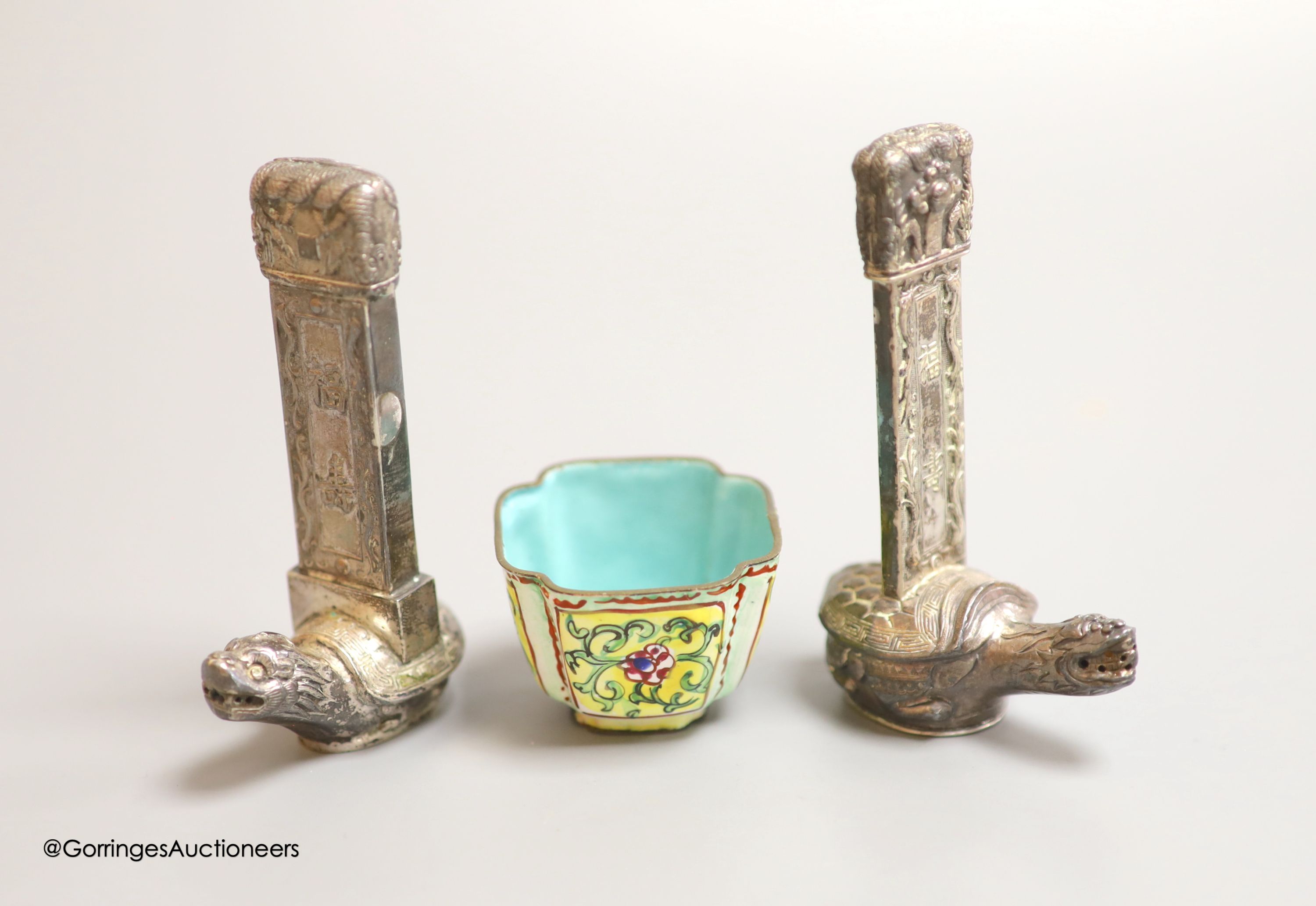 Two Chinese white metal salt and pepper shakers, 9cm and a Canton enamel cup.